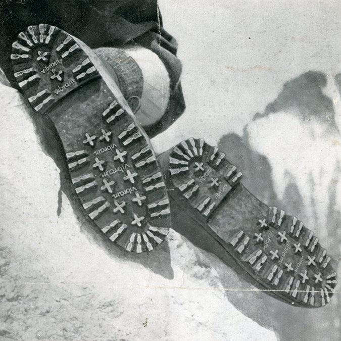 Historic black and white photograph of two Carrarmato soles on snow, with the Vibram name repeated between the lugs